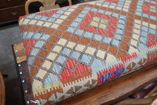 A rectangular Kelim footstool on oak feet, length 114cm, depth 60cm, height 30cm